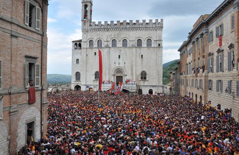 Festa dei Ceri in Gubbio: candles in the middle of a Gubbio street amidst the crowd