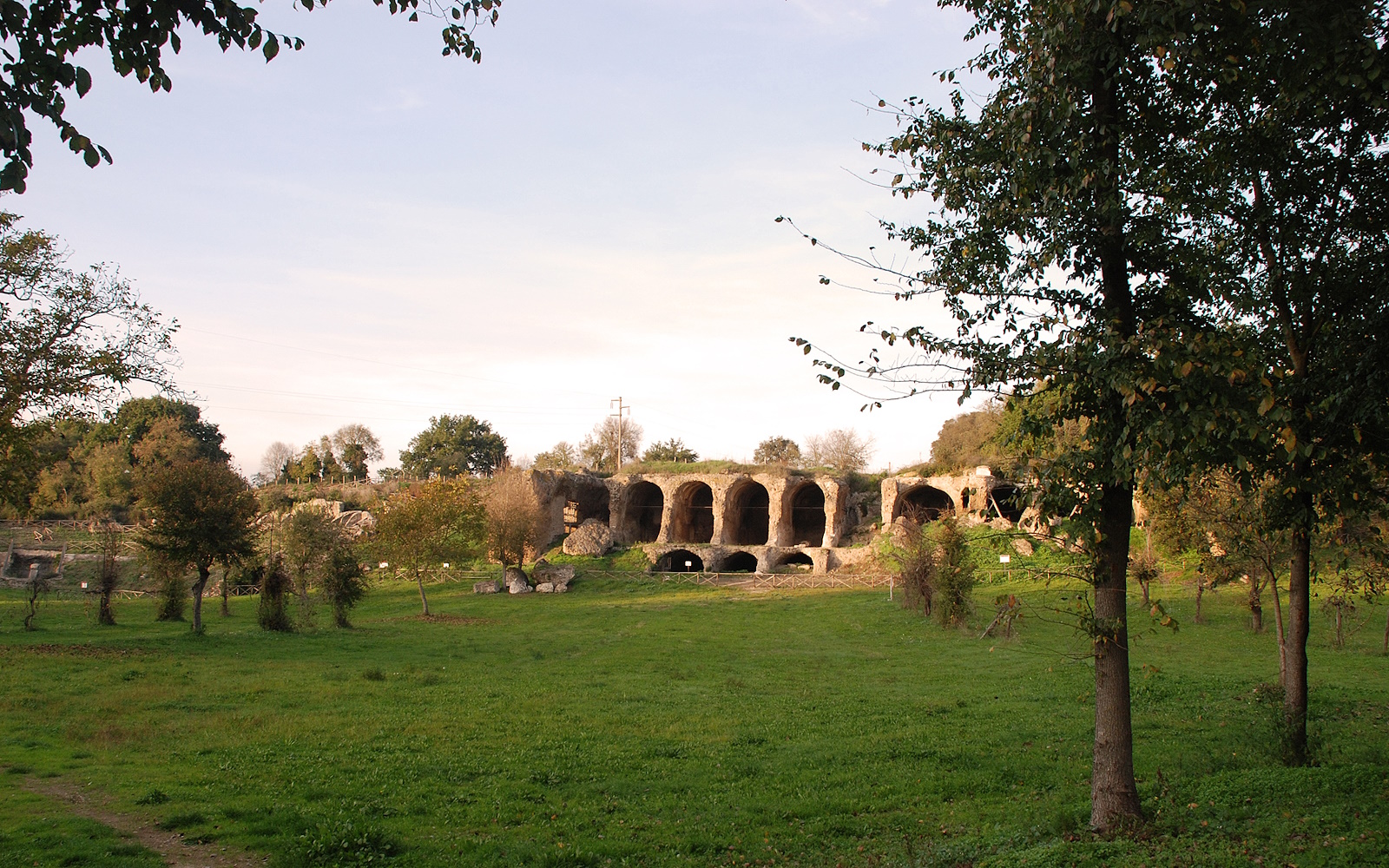Monumental remains of the great substructures of Ocriculum, with arches carved into the rock and surrounding vegetation