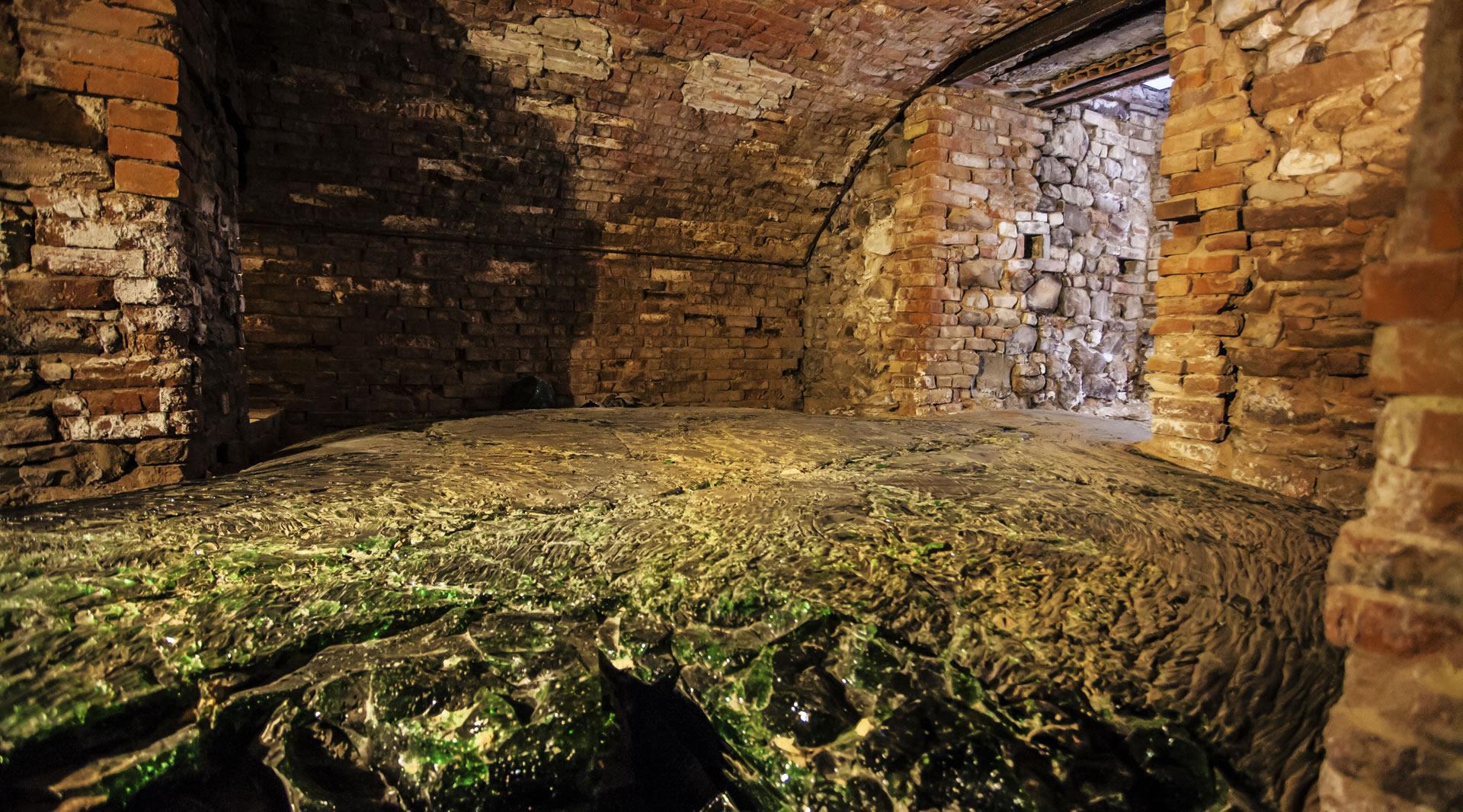 The fusion furnace, now solidified from the last melting, stands as a testament to the ancient technique of glassmaking.