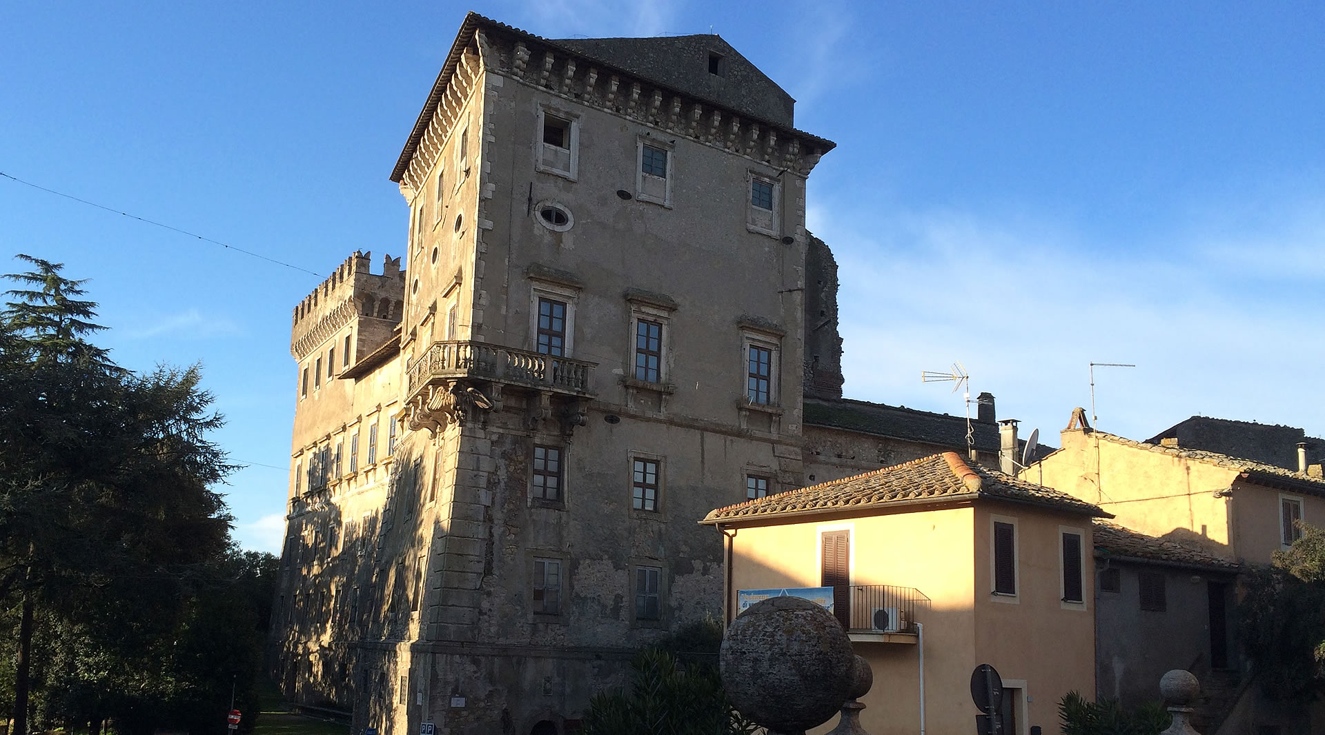 The Castle of Giove, ancient stone fortified palace with tower, lit by the sunset in the Umbrian village.