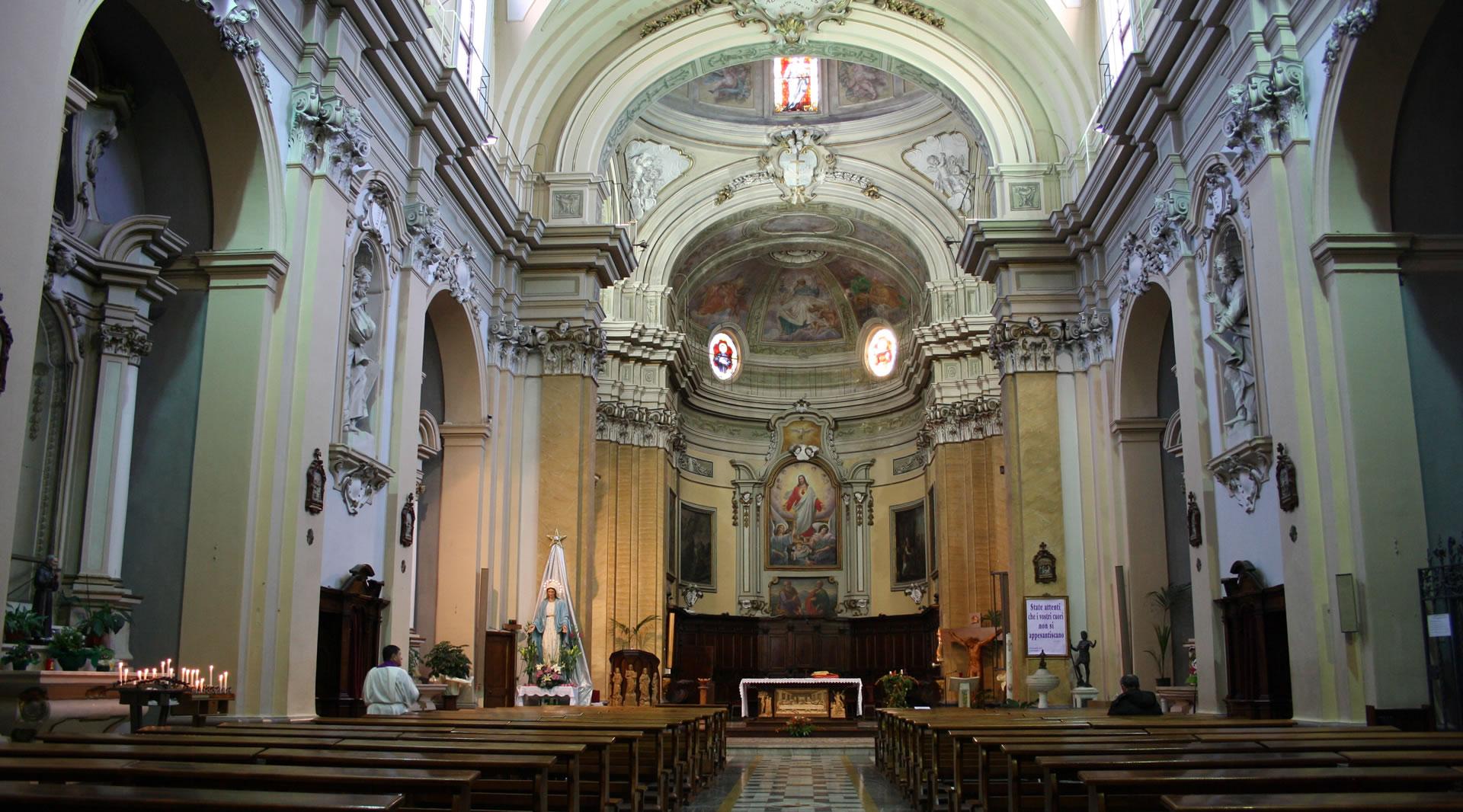 Navata barocca della chiesa di San Francesco ad Amelia, con altare affrescato, cupola decorata, statue e banchi in legno