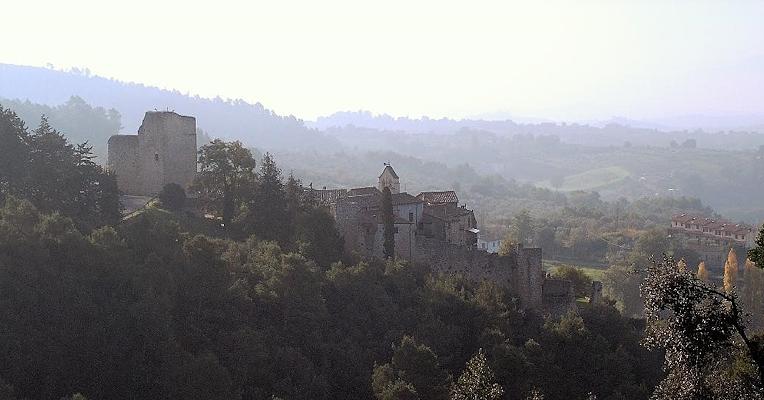 Poggio di Otricoli, an ancient fortified village, rises among Umbrian woods and hills shrouded in mist.