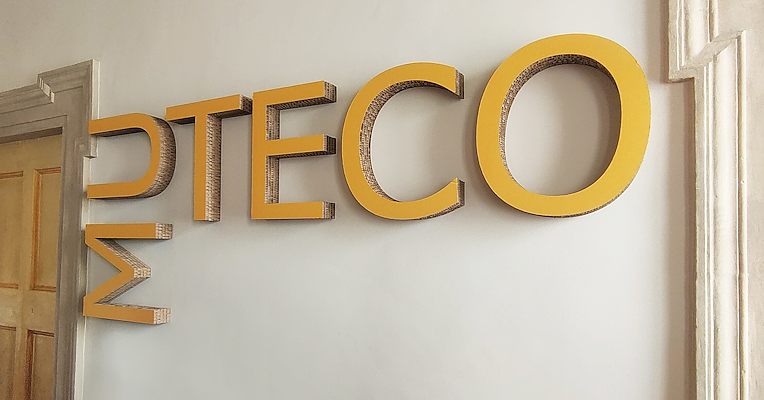 “Muteco” sign in yellow cardboard at the entrance to the Spoleto Textile and Costume Museum