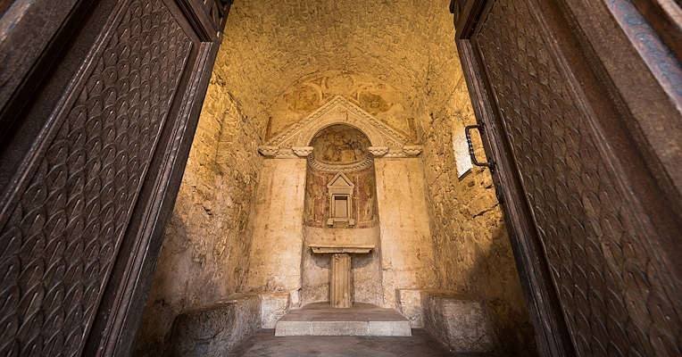 Interior of the Temple of Clitunno, with its doors opening onto the apse, where a small altar is located