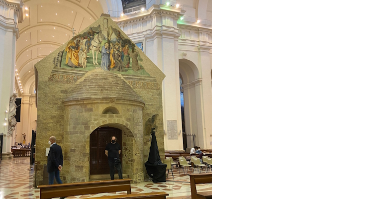 The Porziuncola in Assisi, a small stone chapel with a colorful fresco, inside the Basilica of Santa Maria degli Angeli.