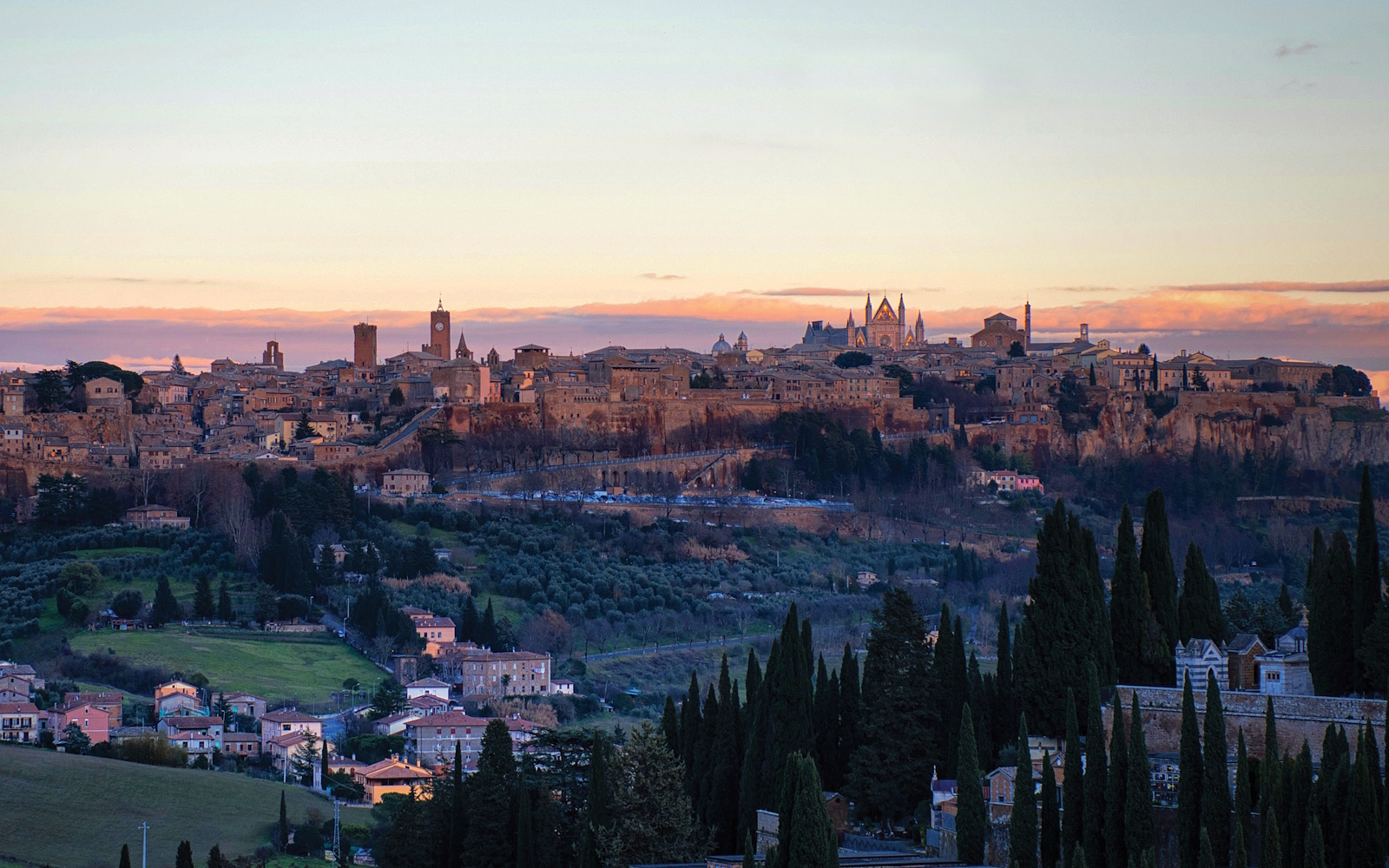 Panoramic view of the city of Orvieto illuminated by the sunset light, resting on its tuff cliff.