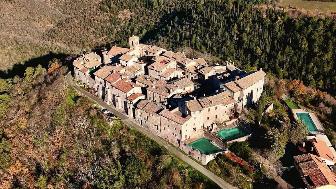 Aerial view of the medieval castle of Macerino in the Monti Martani, surrounded by Umbrian forests