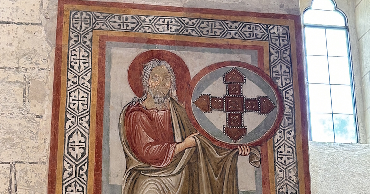 Medieval fresco inside the Church of San Bevignate in Perugia, depicting a sacred figure and Templar cross.